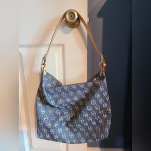 Dooney Bourke denim monogram with gold leather handle. Good condition.